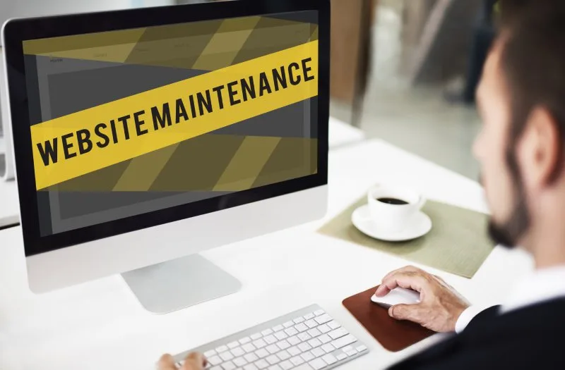 Man sees "website maintenance" alert showing need for ongoing SEO.