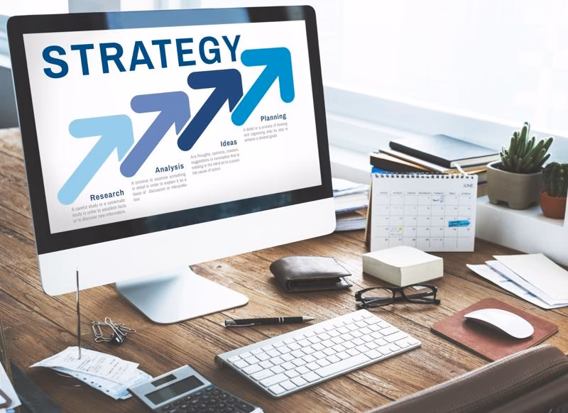 Computer screen displays strategy steps with research, planning, and analysis.