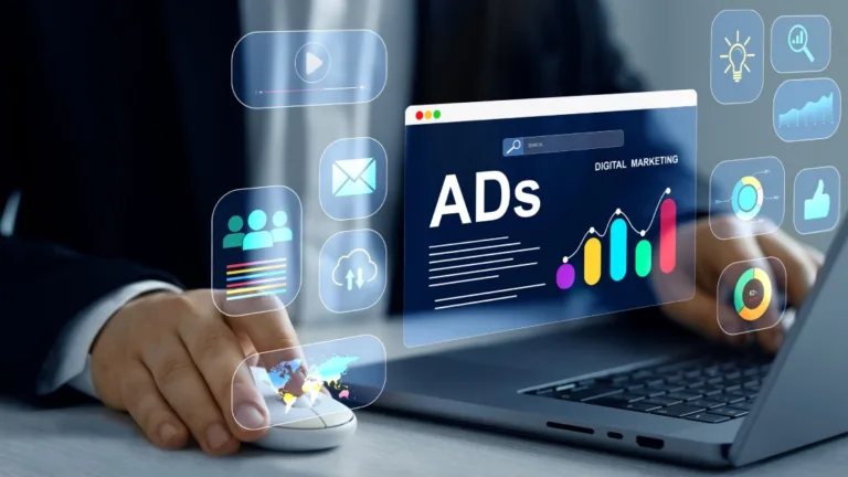 Digital marketer using laptop with advertising analytics icons, illustrating paid search vs paid social strategy differences.
