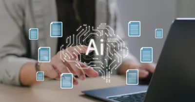 A marketer typing with floating blue document bubbles, symbolizing AI and content marketing.