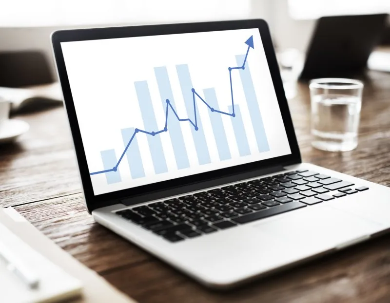Laptop analytics chart showing measurable growth from coordinated digital marketing improvements.