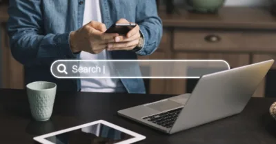 AI search optimization image showing a person using a smartphone with a search bar overlay, representing the online search process