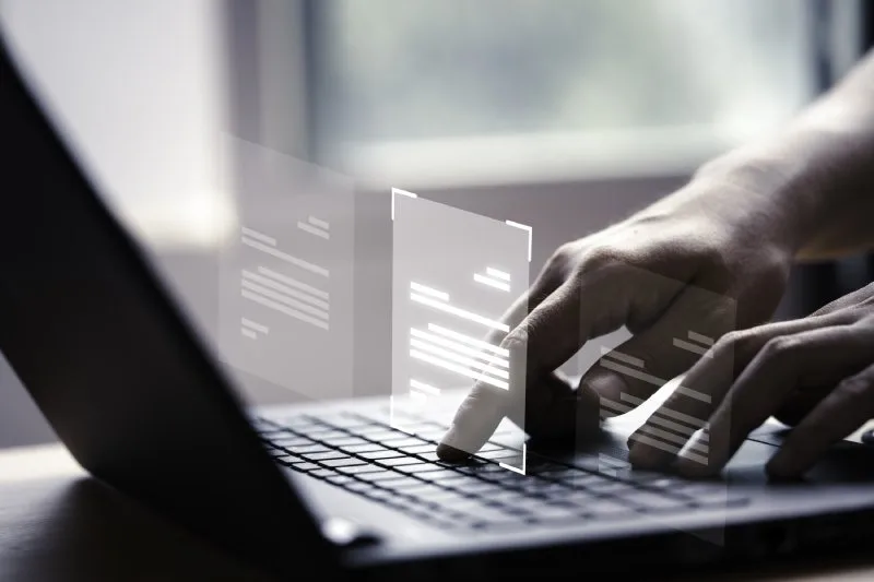 Hands typing code overlaid with data flow, representing leading AI visibility optimization tools in action.