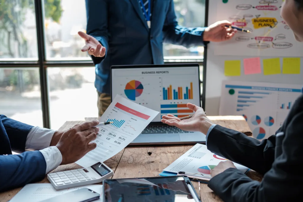 Business team analyzing reports and strategy for wealth management marketing growth.