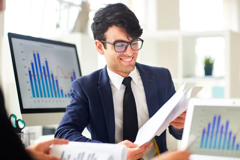 Happy financial advisor, smiling while looking over his SEO audit results