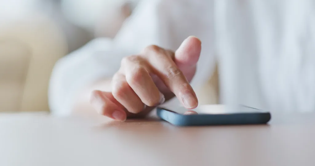 A shot of a hand browsing the phone in AI mode. 