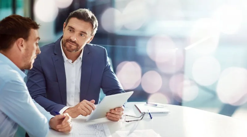 Financial advisor reviewing pipeline data with a client during a consultation meeting.