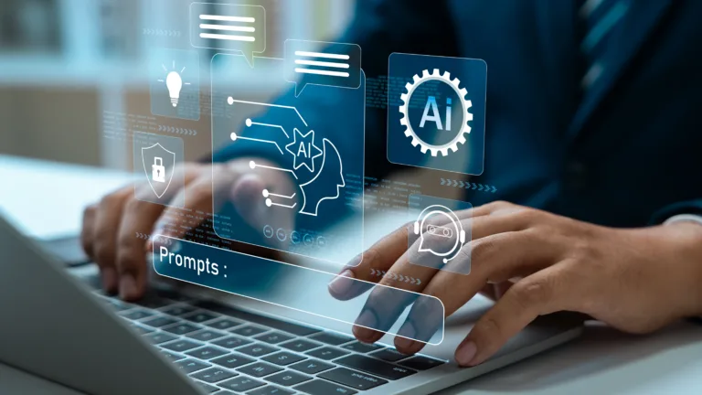 Person using a laptop with holographic AI icons and a prompt bar.