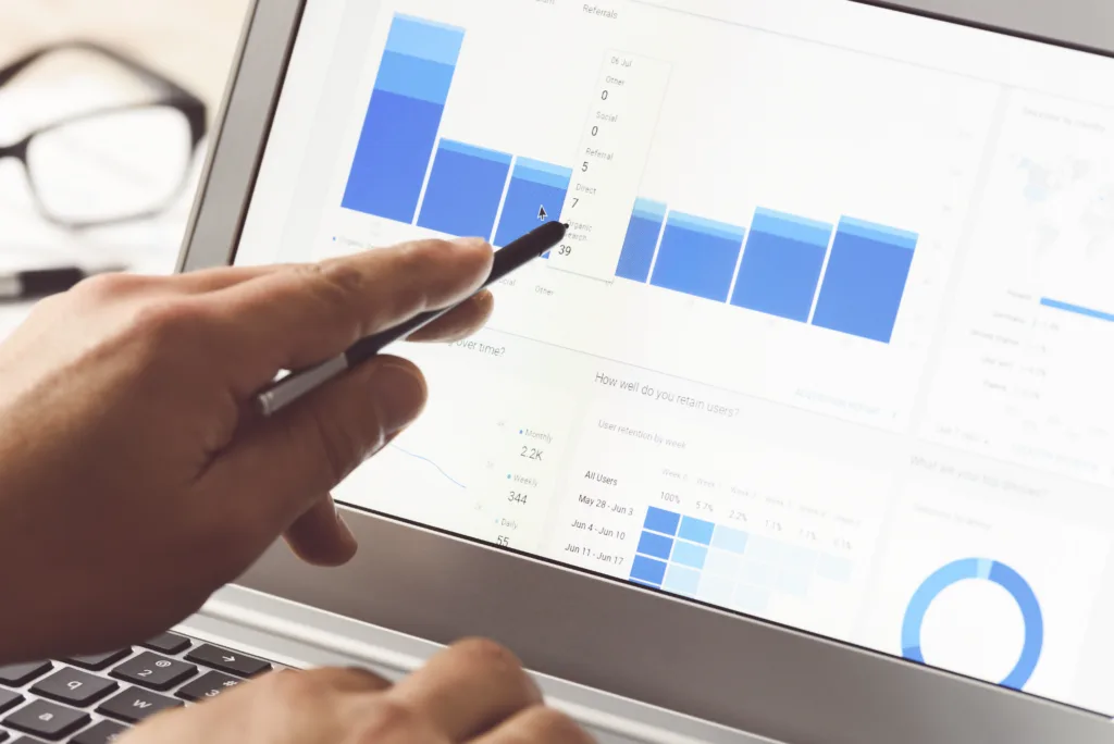Person reviewing analytics charts on a laptop screen.