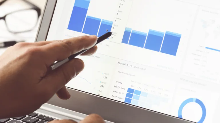 Person reviewing analytics charts on a laptop screen.