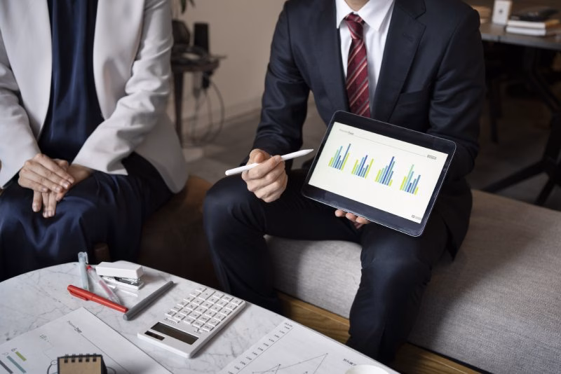 Group of professionals discussing SEO analytics with overlaid bar graph