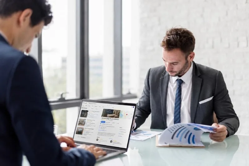 Financial advisor reviewing their wealth management firm’s Google Business Profile on a laptop 