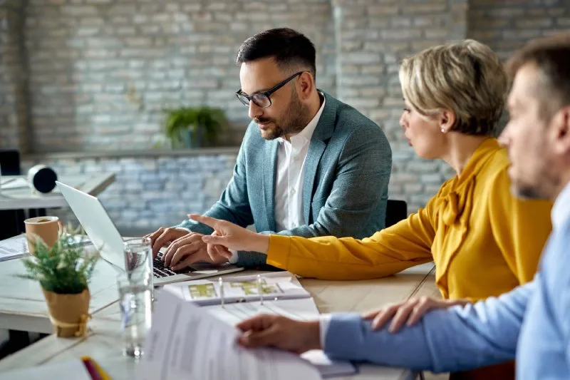 Financial advisor showing local SEO strategy results to clients during a planning session 