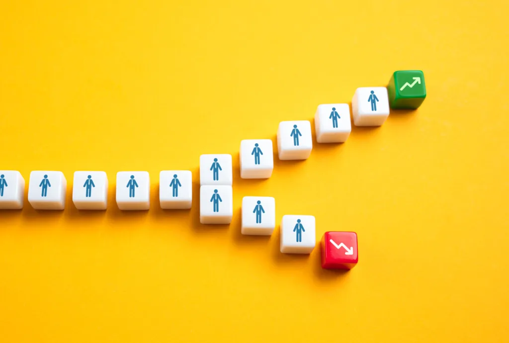 Blocks showing a path of people splitting toward growth and decline.