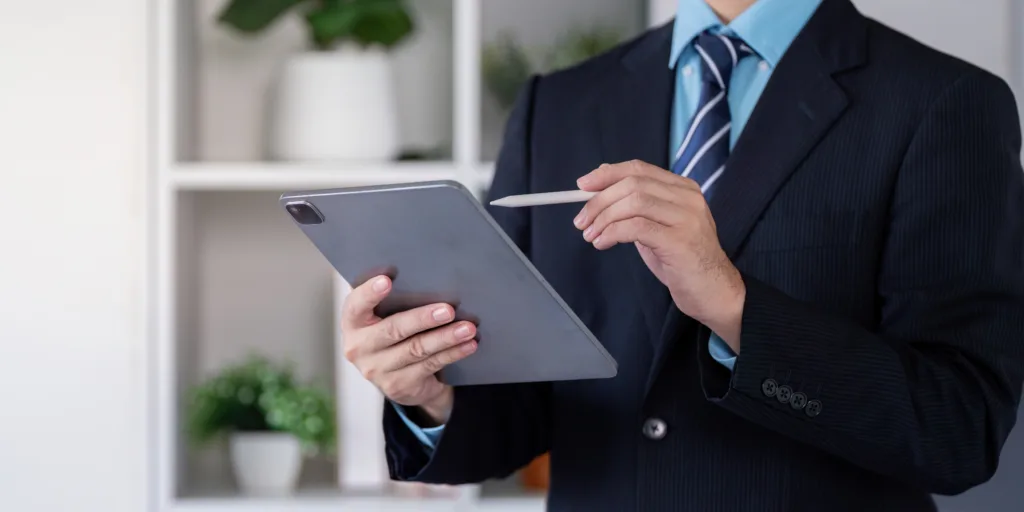 Financial professional using a tablet to review digital marketing insights.