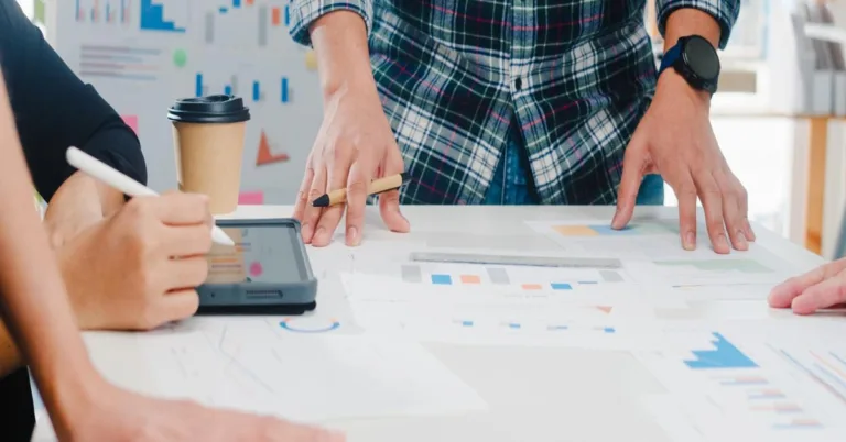 Questions for SEO agency team meeting with charts and tablet.