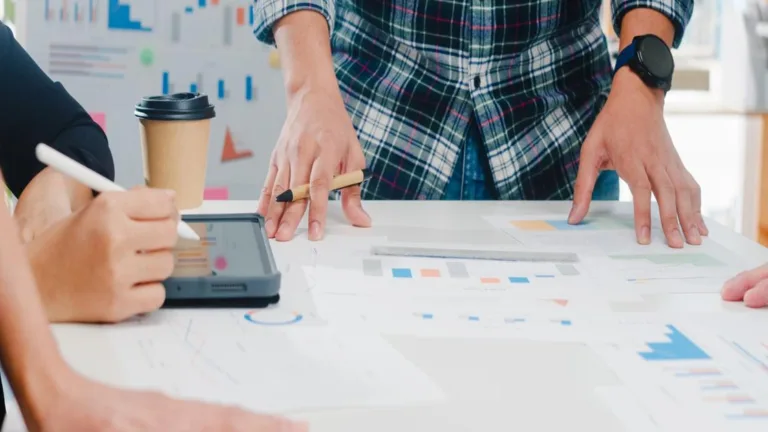 Questions for SEO agency team meeting with charts and tablet.