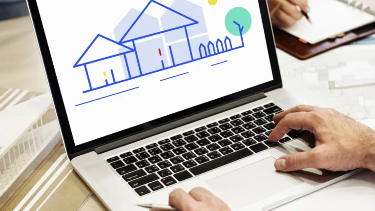 Laptop displaying house illustration while broker evaluates website branding for improved AI visibility in search.