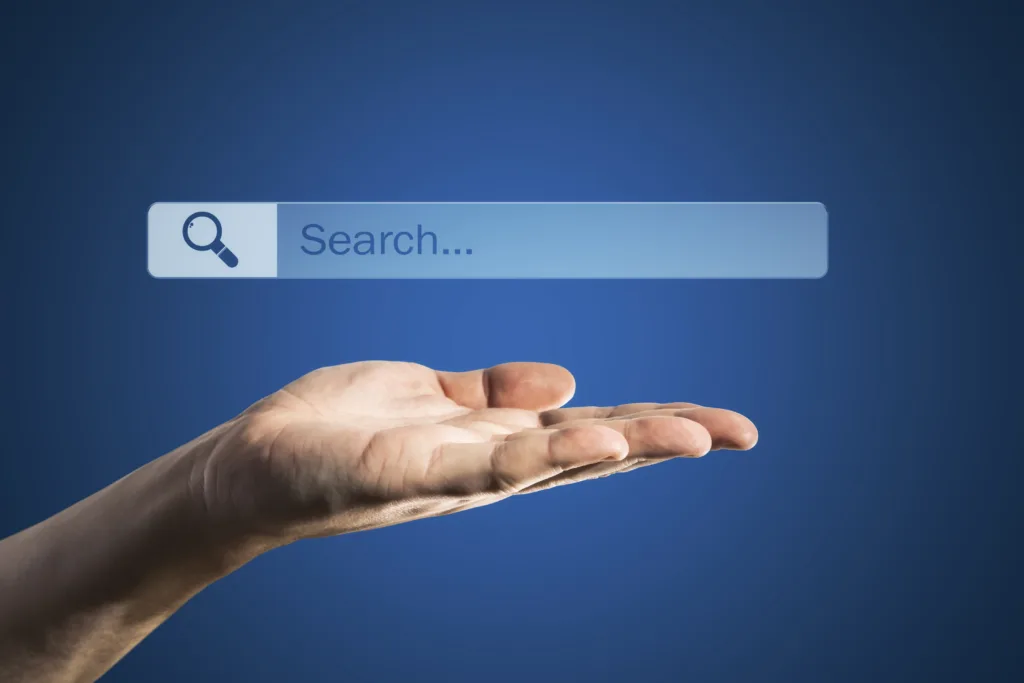 An open human hand holding a floating digital search bar against a solid blue background.