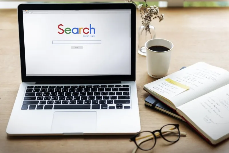 Google search engine homepage on a laptop, representing traditional search visibility and organic rankings