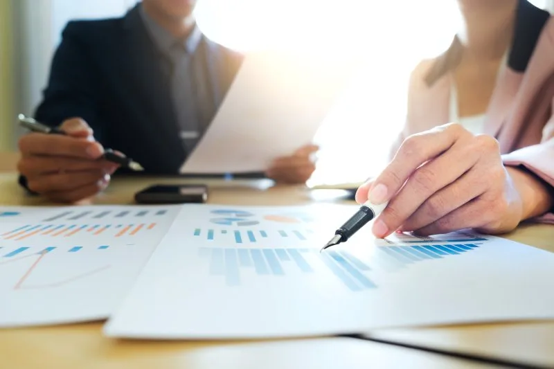 Financial services marketing and sales team reviewing attribution data and qualified pipeline metrics.