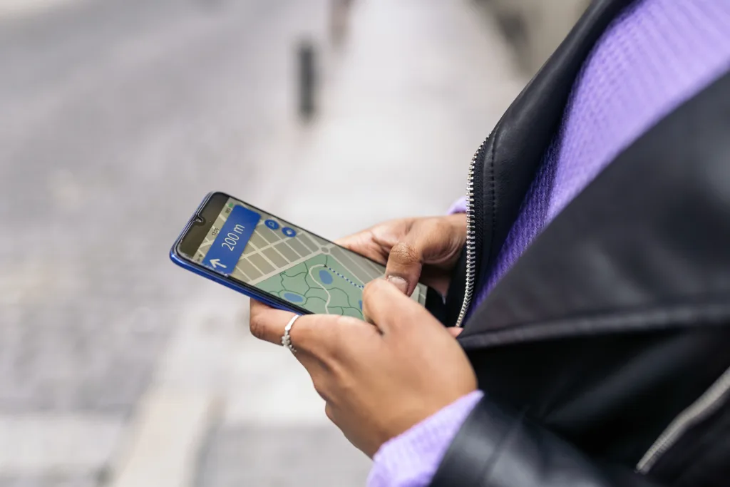 Person using mobile navigation, illustrating how prospects search for local advisors on the go.
