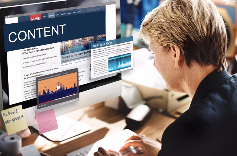 Digital marketer creating various types of content on a computer screen