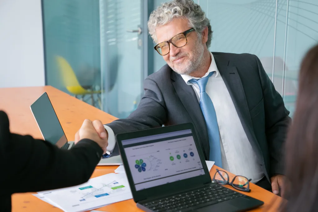 Financial advisor meeting with prospective clients while discussing firm growth strategy