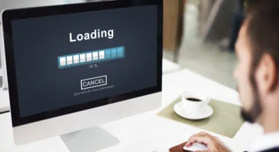 Man watching a slow-loading website, illustrating how site speed affects SEO