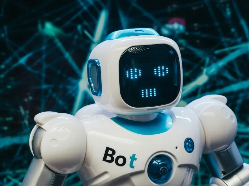 Friendly AI robot with glowing digital background, visually explaining what an SEO AI agent is.