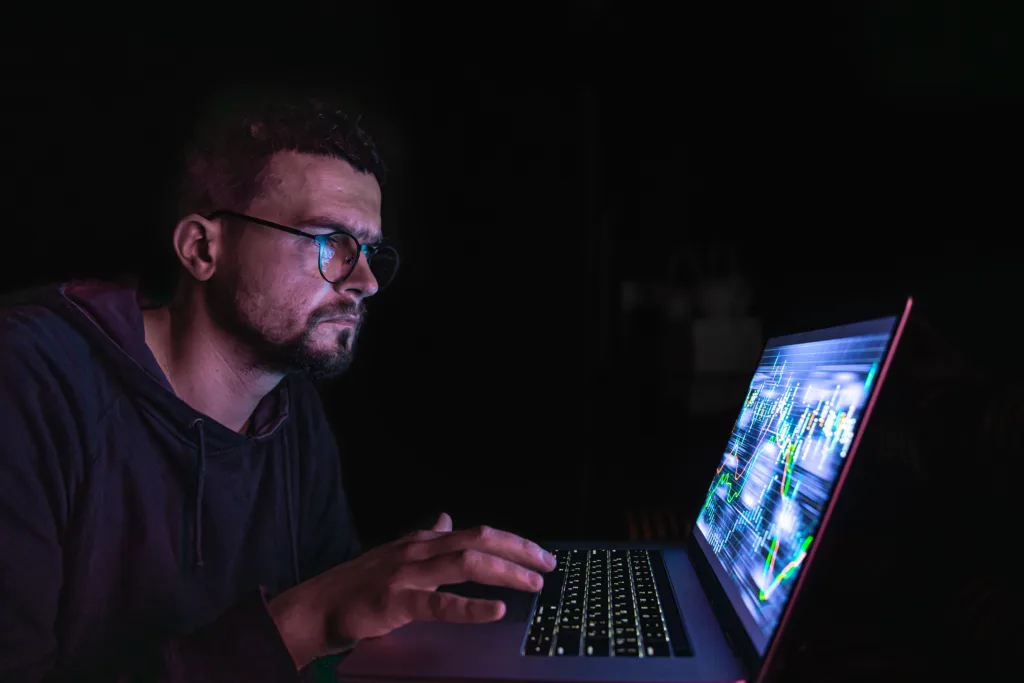 Marketer analyzing Meta Andromeda ad performance data on a laptop screen at night